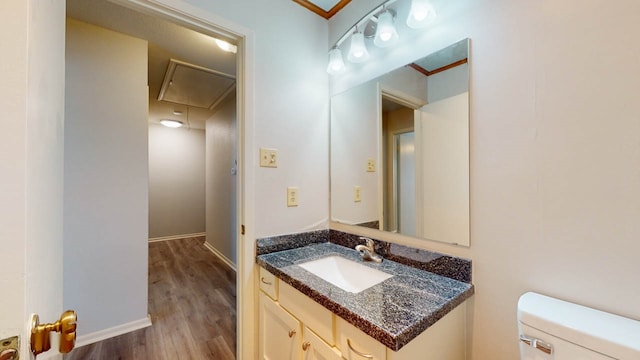 bathroom with wood-type flooring, vanity, and toilet