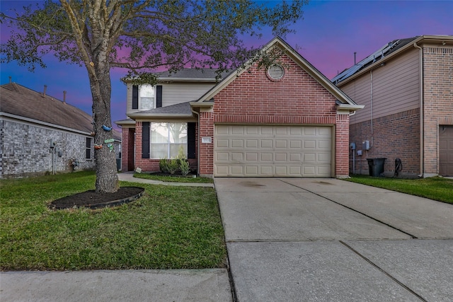 view of front property featuring a lawn and a garage