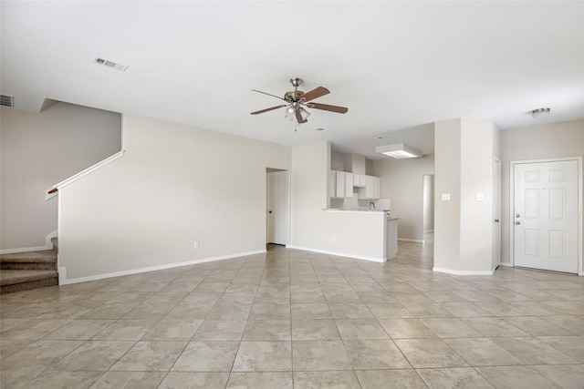 unfurnished living room with ceiling fan and light tile patterned floors