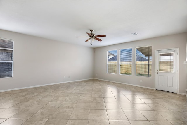 empty room featuring ceiling fan and light tile patterned floors