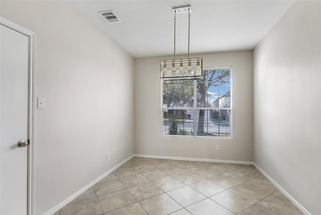 unfurnished dining area featuring light tile patterned flooring