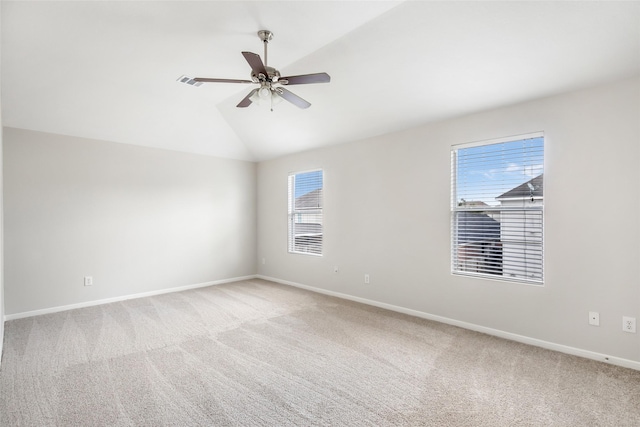 carpeted empty room with ceiling fan and vaulted ceiling