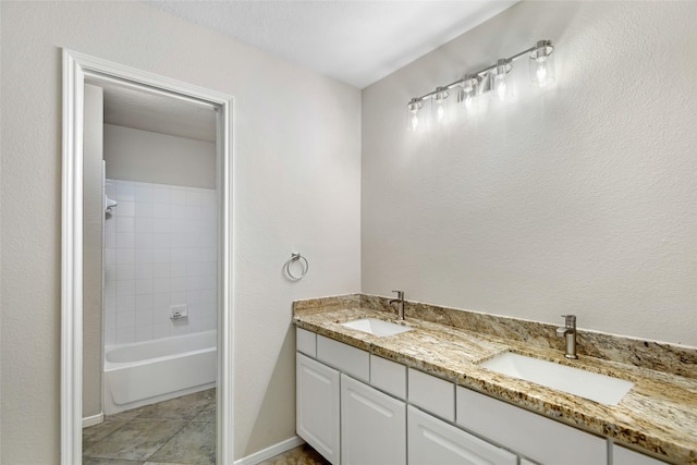 bathroom with tiled shower / bath combo, vanity, and tile patterned floors