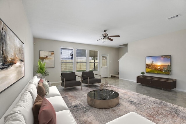 living room featuring light tile patterned floors and ceiling fan