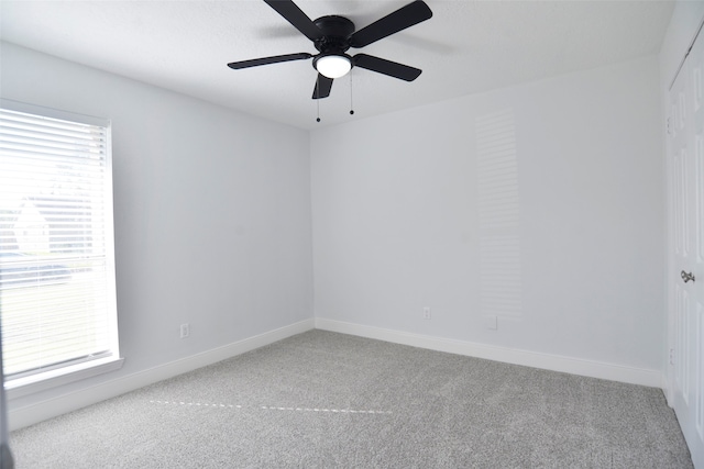 empty room featuring carpet floors and ceiling fan