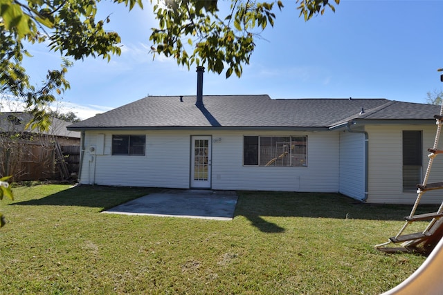 rear view of property with a patio and a lawn