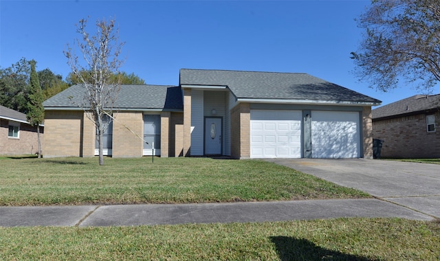 ranch-style house featuring a garage and a front lawn