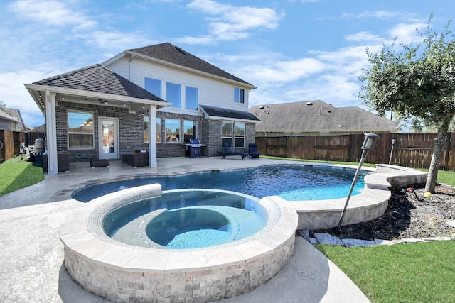 view of swimming pool featuring an in ground hot tub, a patio, and area for grilling