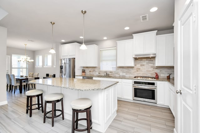 kitchen with white cabinetry, a kitchen island, and stainless steel appliances