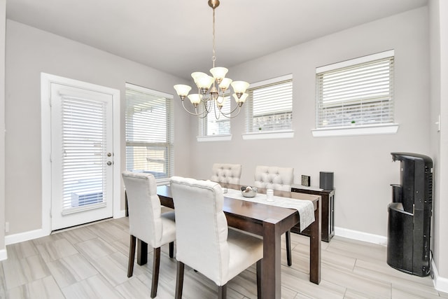 dining room with a healthy amount of sunlight and a chandelier