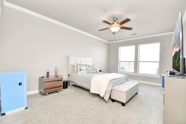 carpeted bedroom with ceiling fan and crown molding