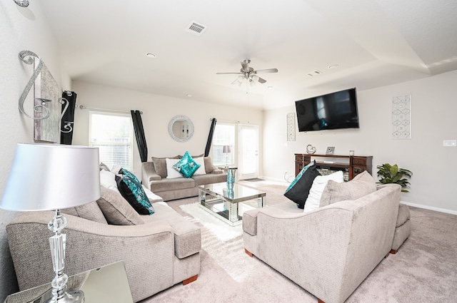 living room featuring light carpet and a wealth of natural light