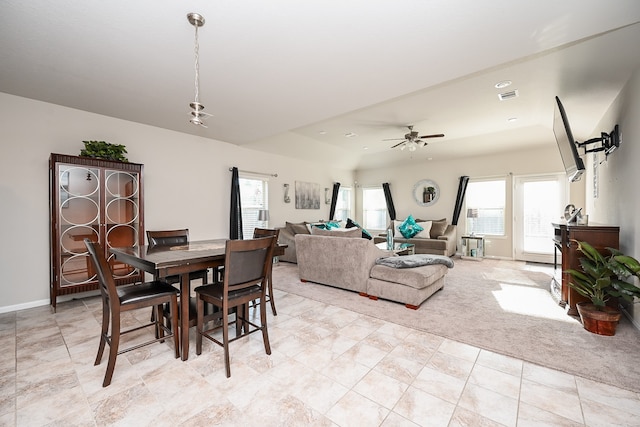 dining room with ceiling fan, light carpet, and a wealth of natural light