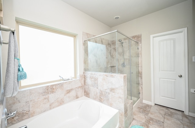 bathroom featuring shower with separate bathtub