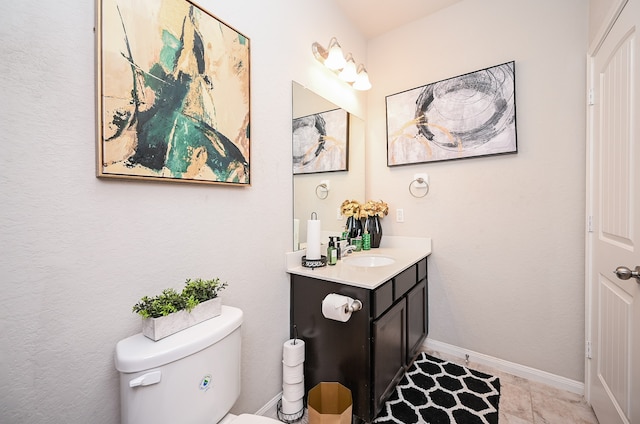 bathroom featuring tile patterned flooring, vanity, and toilet