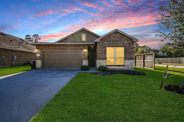 view of front of home with a lawn and a garage