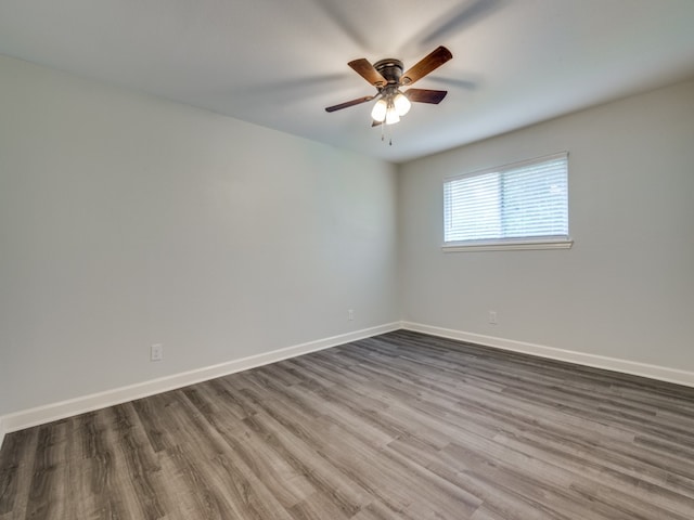 empty room with hardwood / wood-style floors and ceiling fan