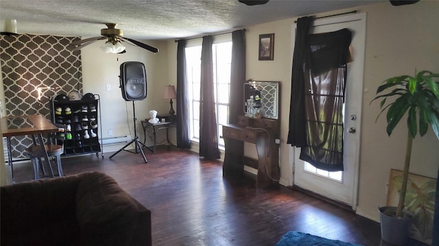 809 8th Ave N, Texas City, TX 77590 - living area with a textured ceiling, a ceiling fan, wood finished floors, and a baseboard radiator