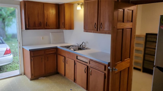 809 8th Ave N, Texas City, TX 77590 - kitchen featuring light countertops, brown cabinets, and freestanding refrigerator