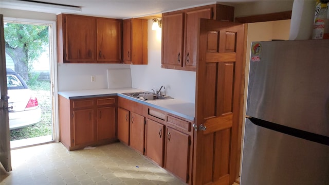 kitchen featuring stainless steel refrigerator and sink