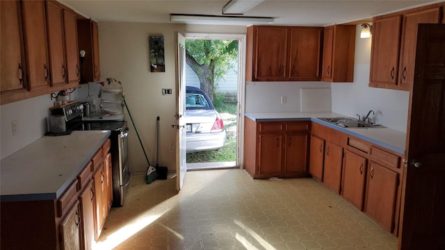 809 8th Ave N, Texas City, TX 77590 - kitchen with stainless steel electric range, light countertops, and brown cabinets