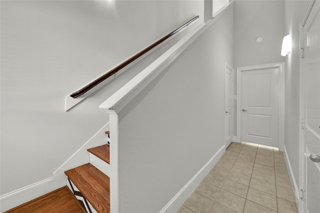 stairway with tile patterned floors