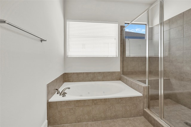 bathroom with tile patterned flooring and separate shower and tub