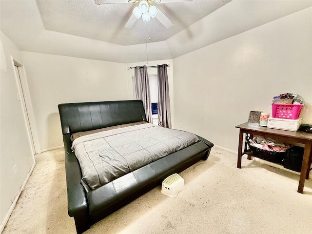 carpeted bedroom with a textured ceiling, ceiling fan, and lofted ceiling