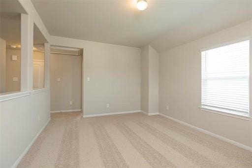 spare room with light colored carpet