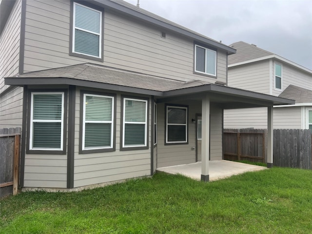 rear view of property with a patio area and a yard