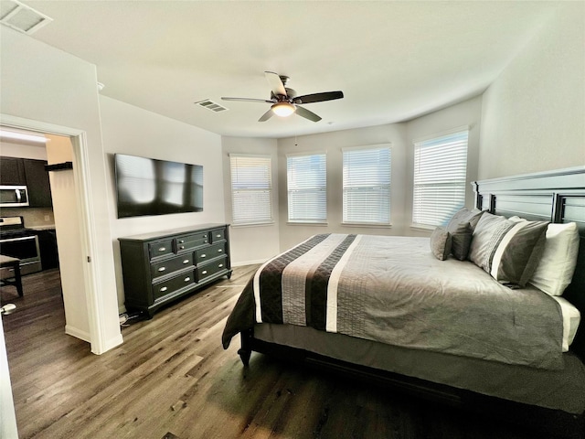 bedroom with ceiling fan and hardwood / wood-style floors