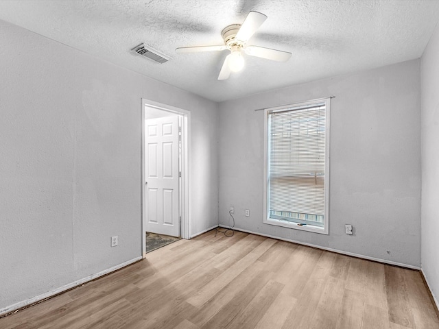 4808 Mcewen St, Houston, TX 77009 - unfurnished room featuring wood finished floors, a ceiling fan, and a textured ceiling