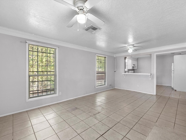4808 Mcewen St, Houston, TX 77009 - empty room featuring a ceiling fan, light tile patterned floors, a textured ceiling, and crown molding