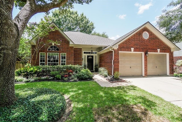 view of front of property with a front yard and a garage