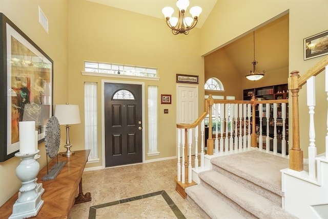 entryway with a notable chandelier and high vaulted ceiling