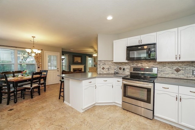 kitchen featuring pendant lighting, white cabinets, a kitchen breakfast bar, stainless steel electric range oven, and kitchen peninsula