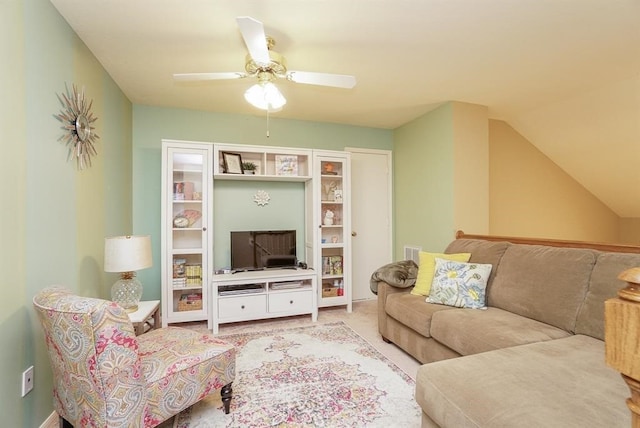 living room featuring ceiling fan, carpet floors, and vaulted ceiling