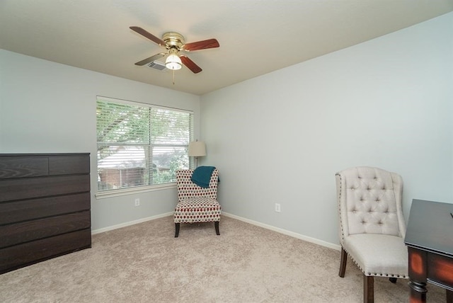 living area with ceiling fan and light colored carpet