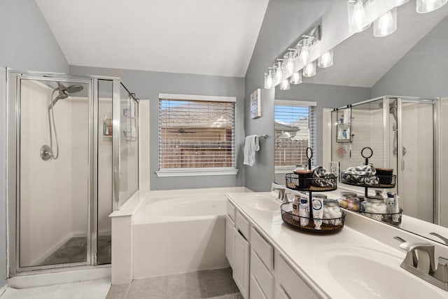 bathroom featuring tile patterned flooring, vanity, separate shower and tub, and lofted ceiling