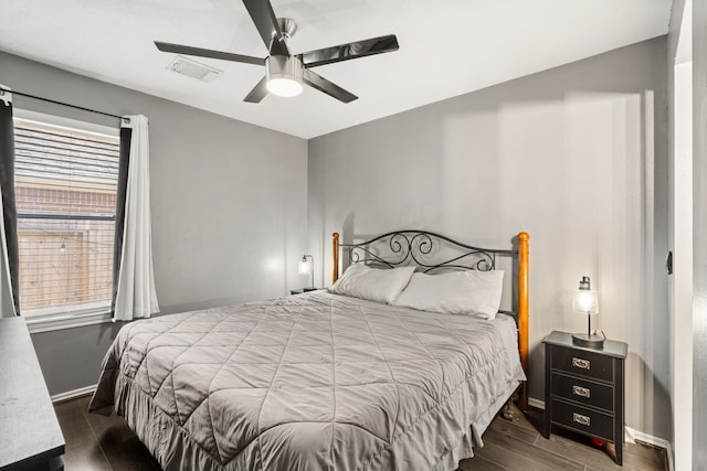 bedroom with ceiling fan and dark wood-type flooring