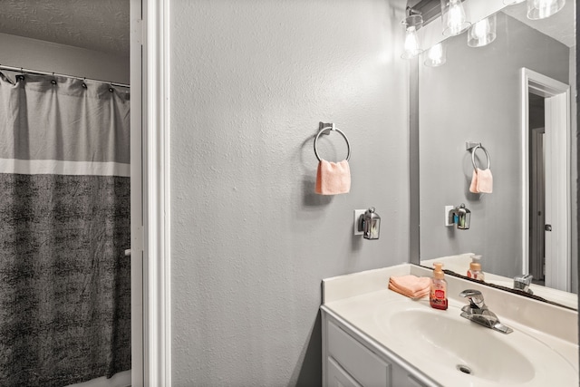 bathroom with vanity and a textured ceiling