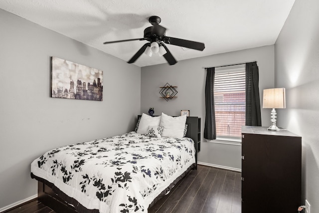 bedroom with ceiling fan and dark wood-type flooring