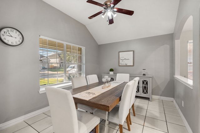 tiled dining room featuring ceiling fan and vaulted ceiling