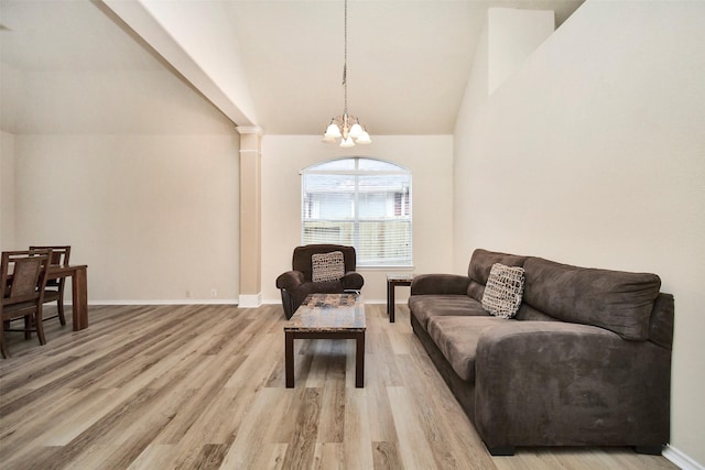 living room with vaulted ceiling, a chandelier, and light wood-type flooring