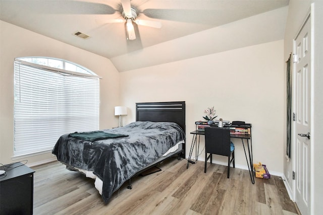 bedroom with lofted ceiling, ceiling fan, and light hardwood / wood-style flooring