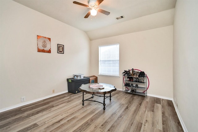 sitting room featuring hardwood / wood-style flooring, vaulted ceiling, and ceiling fan