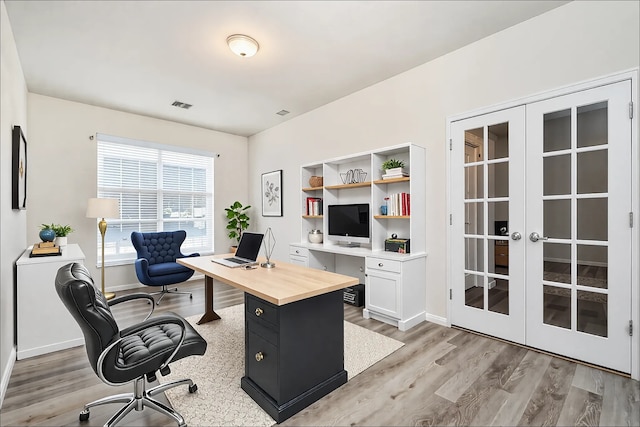 office space featuring light wood-type flooring and french doors