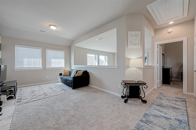 sitting room featuring light colored carpet and vaulted ceiling