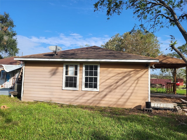 view of side of home with a lawn