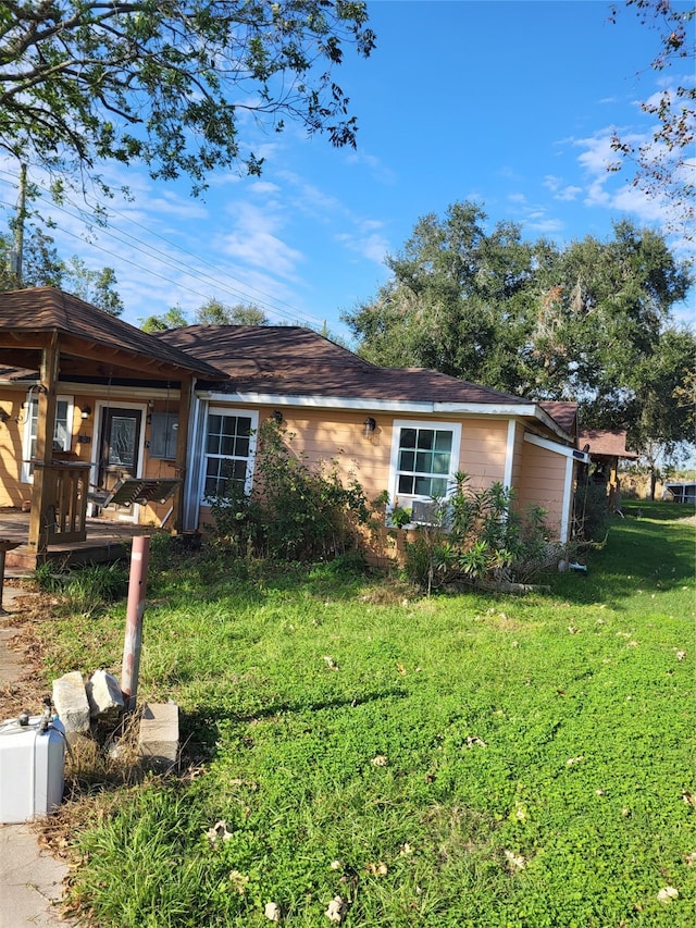 view of side of home with a yard